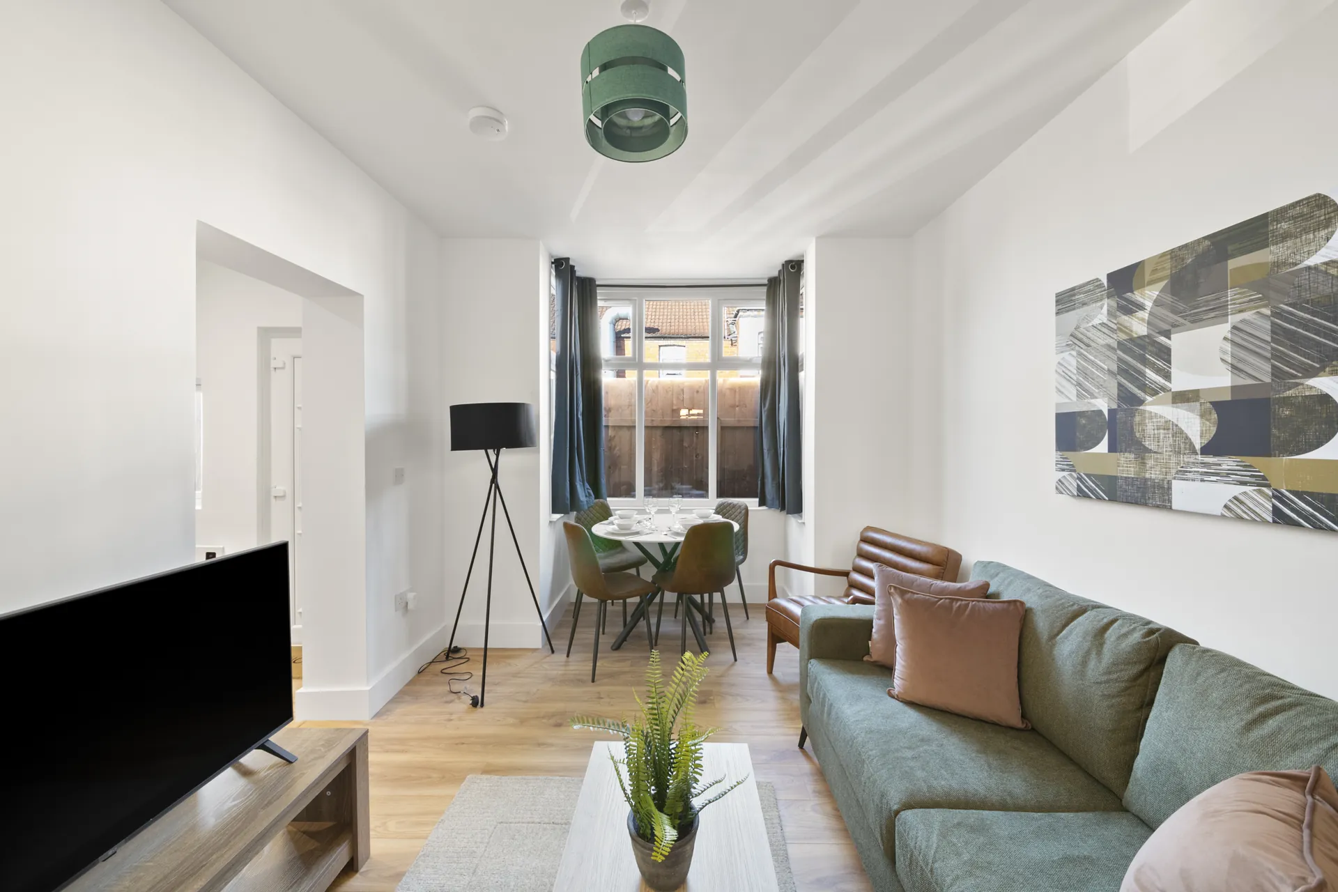 Looking across the living room toward the dining table and window