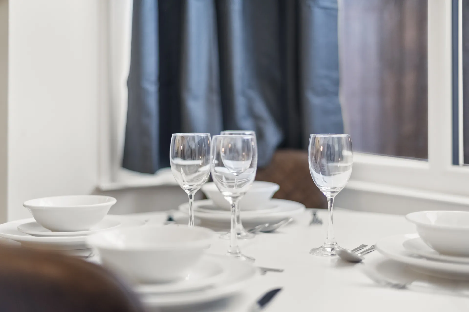 Glassware, crockery and cutlery for four, already in the cupboards