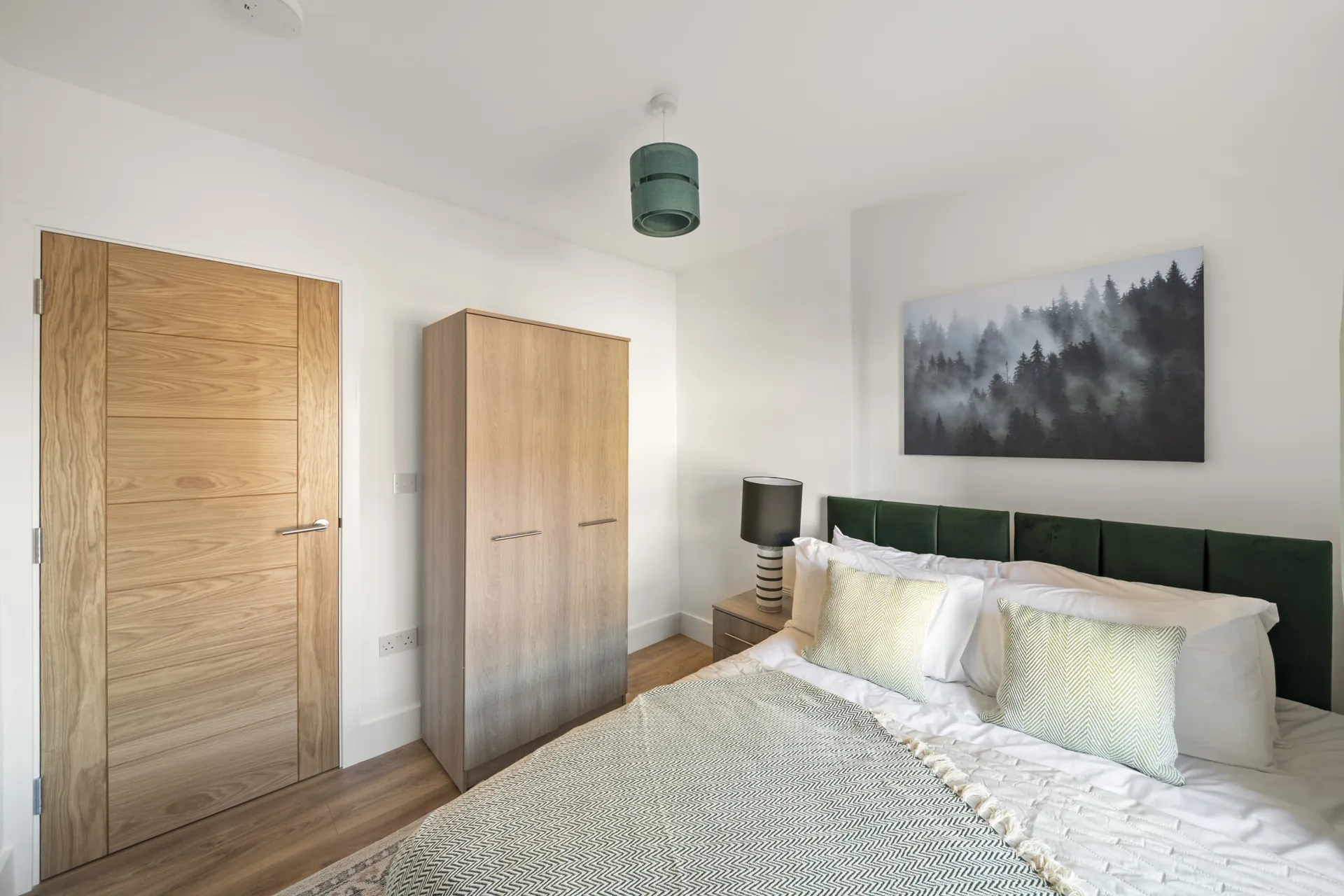 Fitted wardrobe standing beside the bed