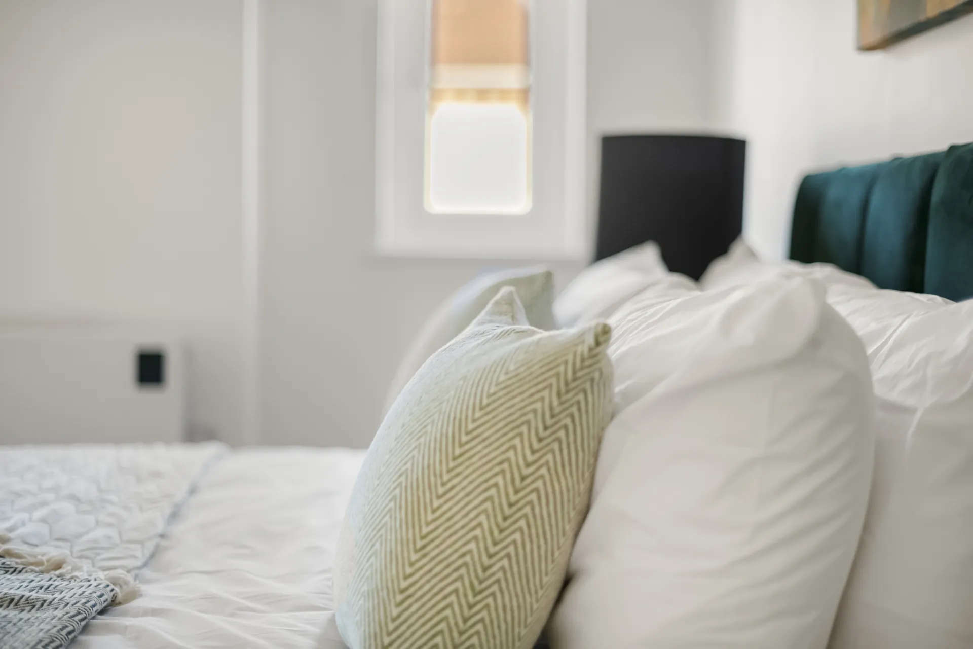 Extra cushions and a throw on every bed